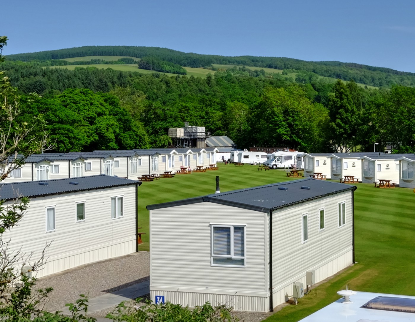 View of holiday homes at Fonab Caravan Park with large green space in the middle