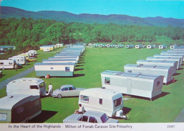 Retro Caravans fromthe 1970's and static homes in the foregound, in a row leading towards the back of Fonab's Caravan Palr. 1970's cars are towing guest's holiday caravans.