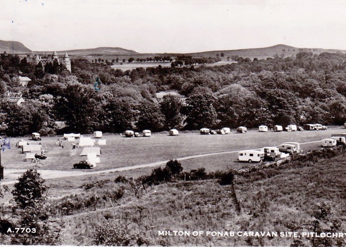 Fonab Caravan Park back in 1952. A narrow gravel road with small caravans spread amongst the site's grassed area. Black and White Photo