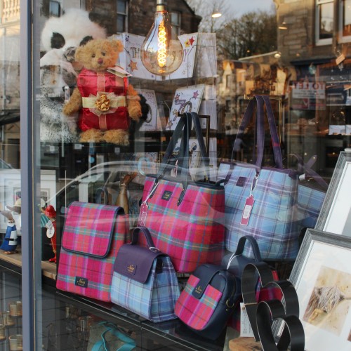 Shops lit up in December in Pitlochry High Street